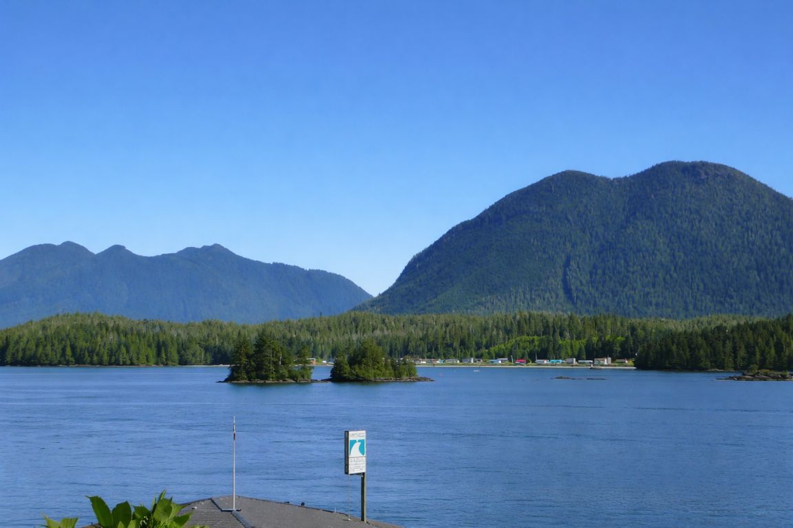 Peaceful Clayoquot Sound landscape with calm water and coastal mountains captured during Tofino Tour Packages experience