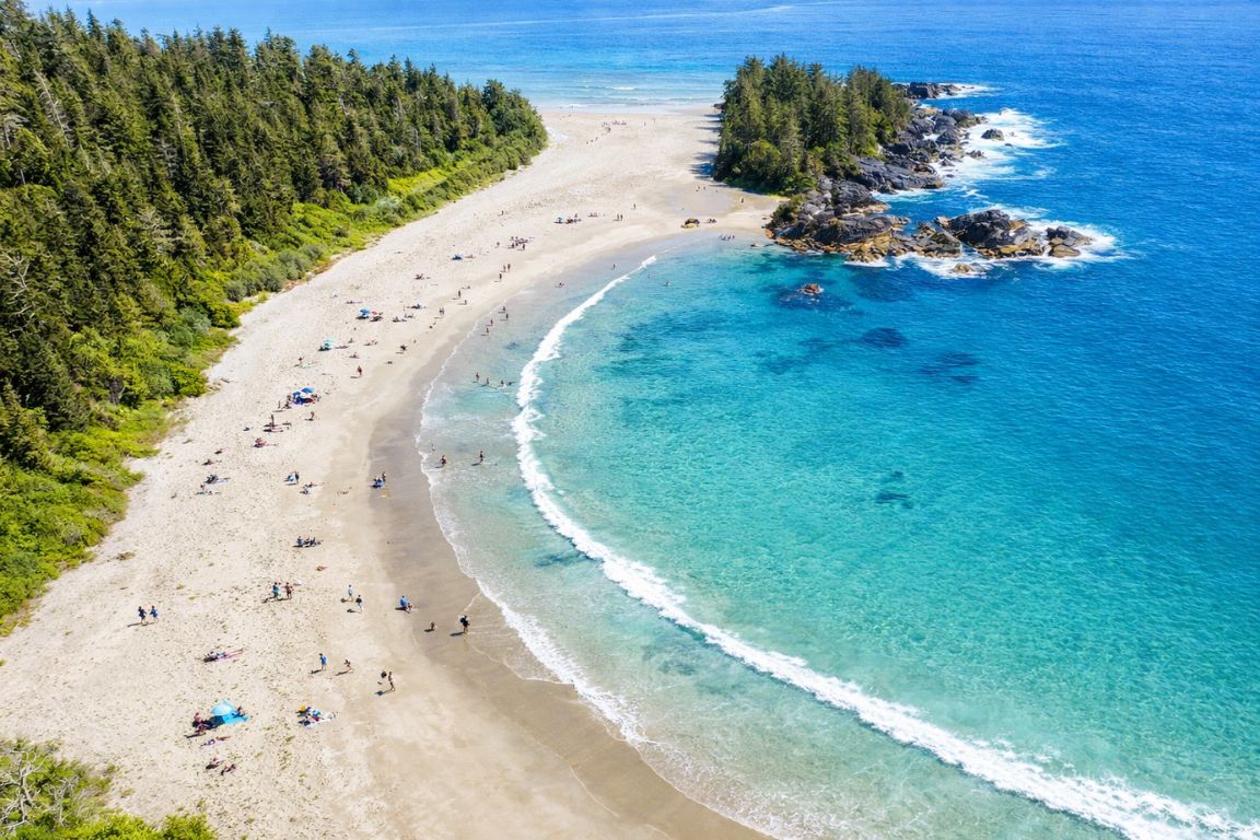 Aerial view of Cox Bay Beach in Tofino with turquoise water and sandy shoreline during a tour with Tofino Tour Packages
