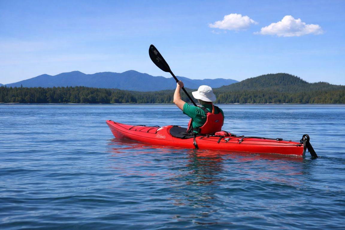 Solo kayaking activity in Tofino with stunning mountain and ocean views during Tofino Tour Packages trip