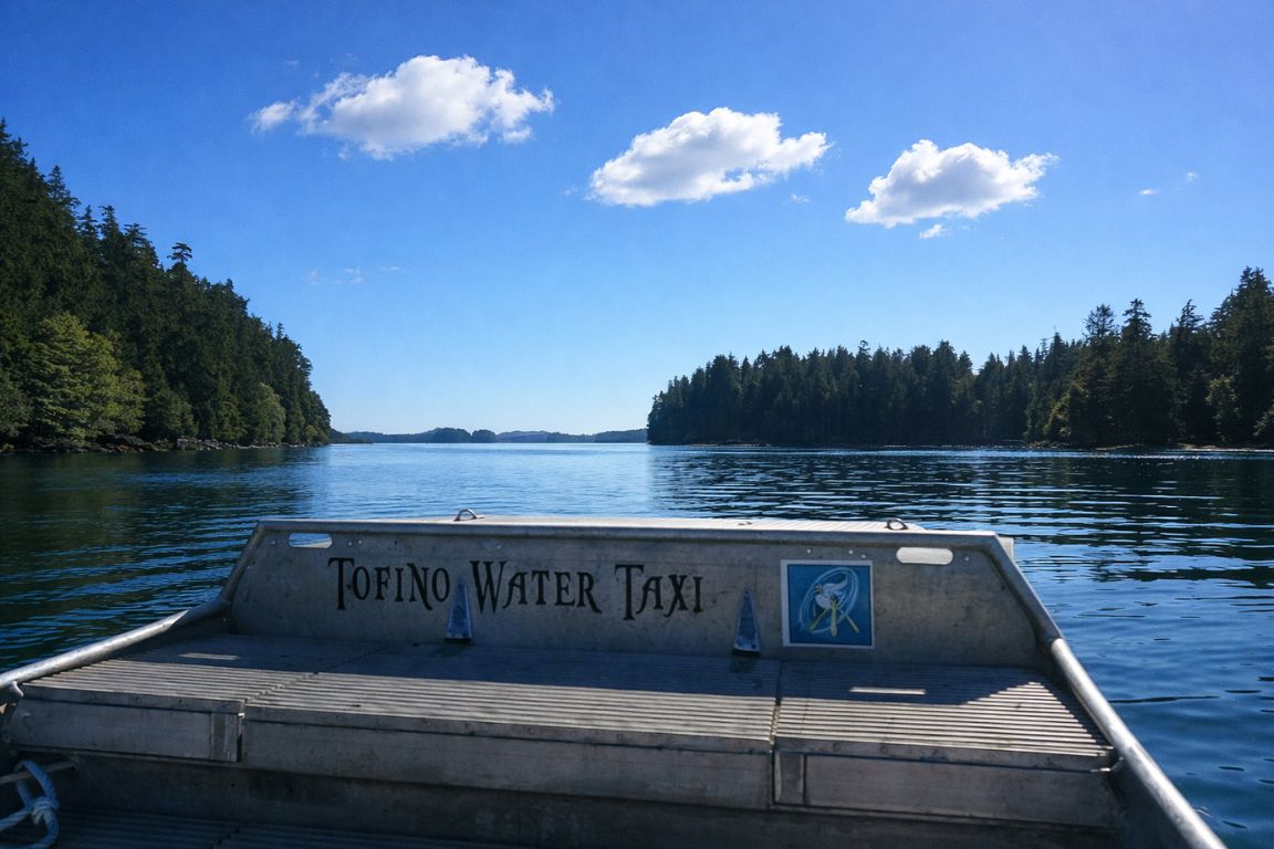 Tofino water taxi boat view across calm ocean and forest islands during a tour with Tofino Tour Packages